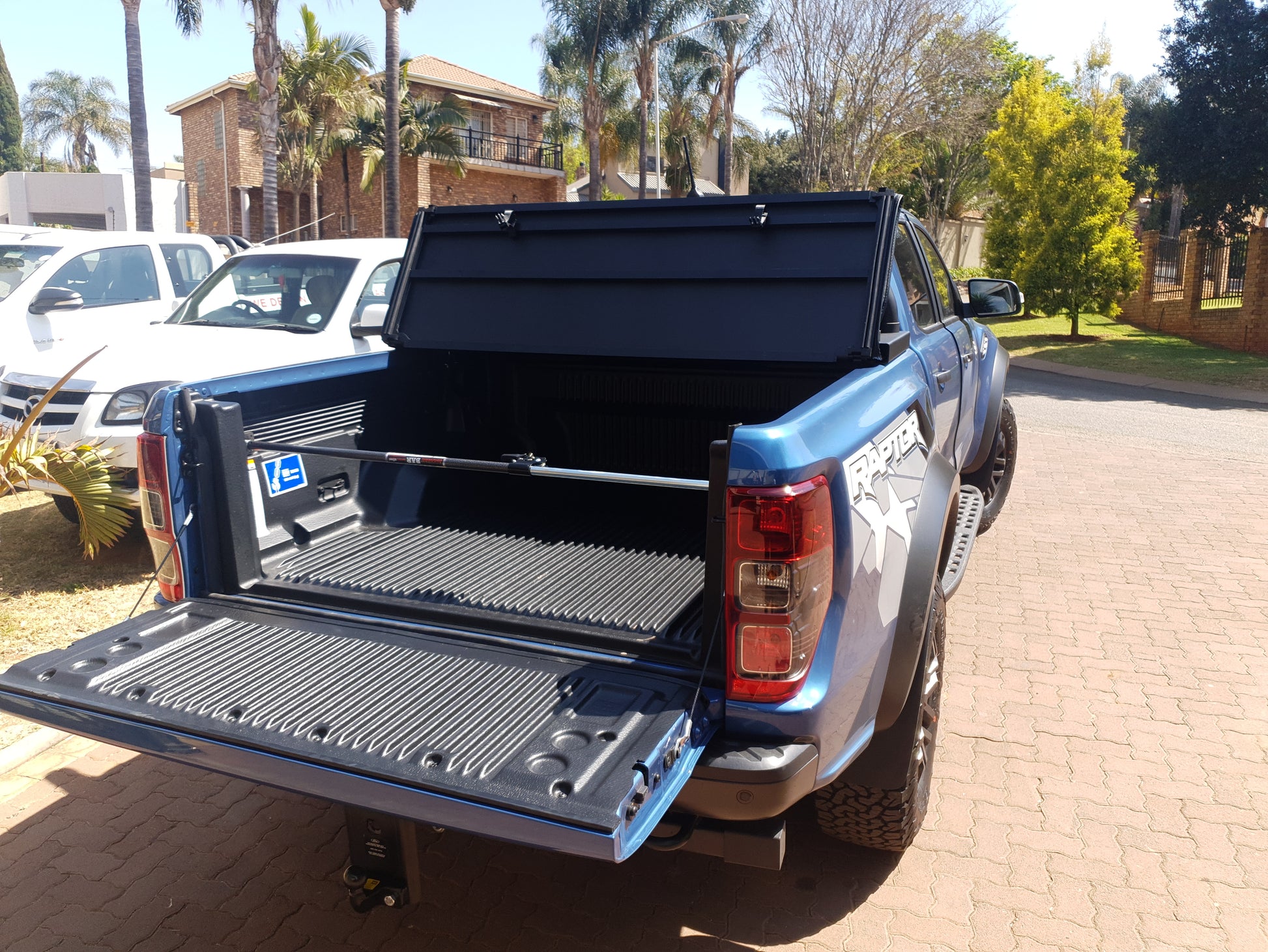 Ratchet-type cargo bar installed on back of utility vehicle.