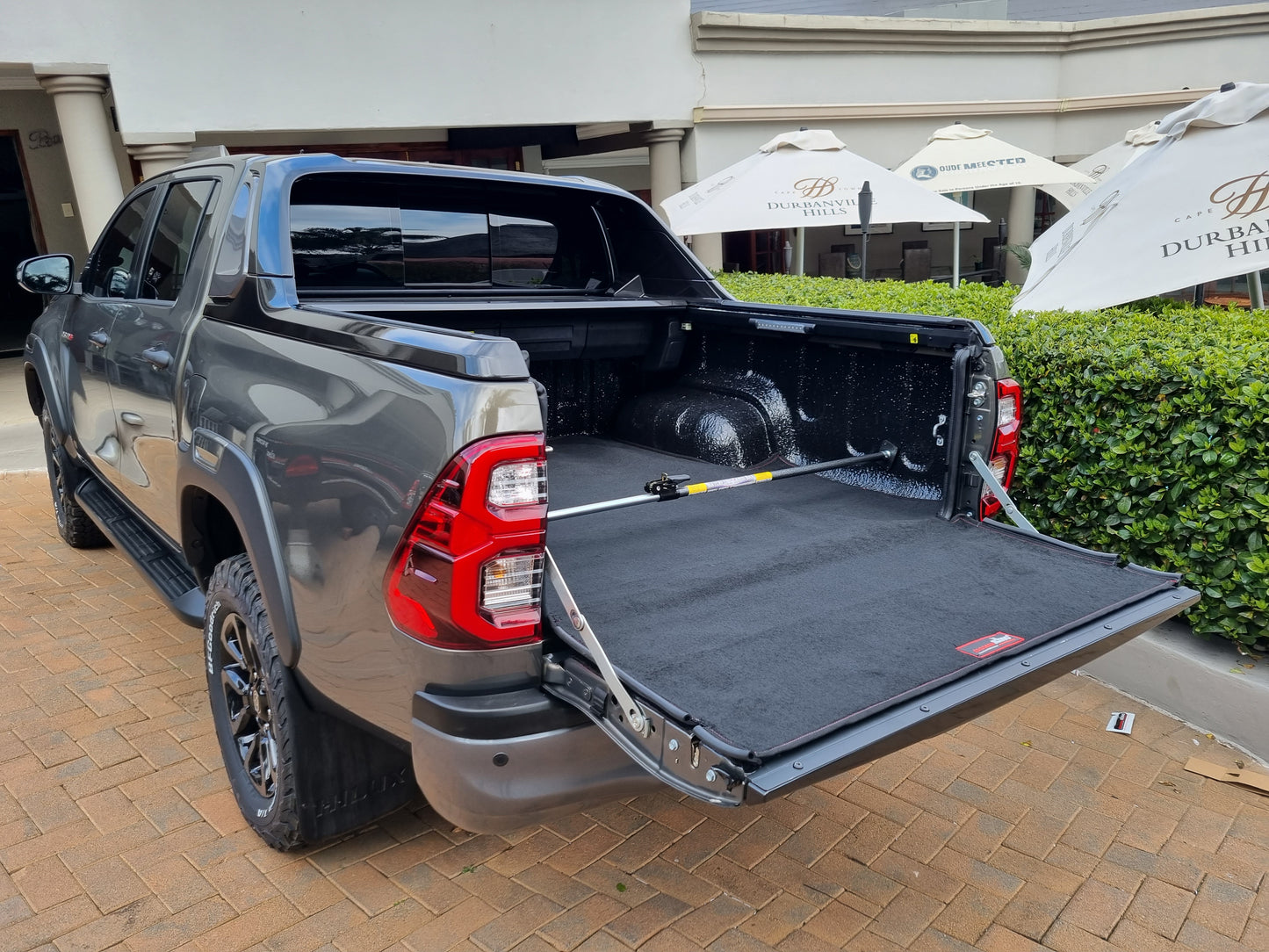 Ratchet-type cargo bar installed on back of utility vehicle.